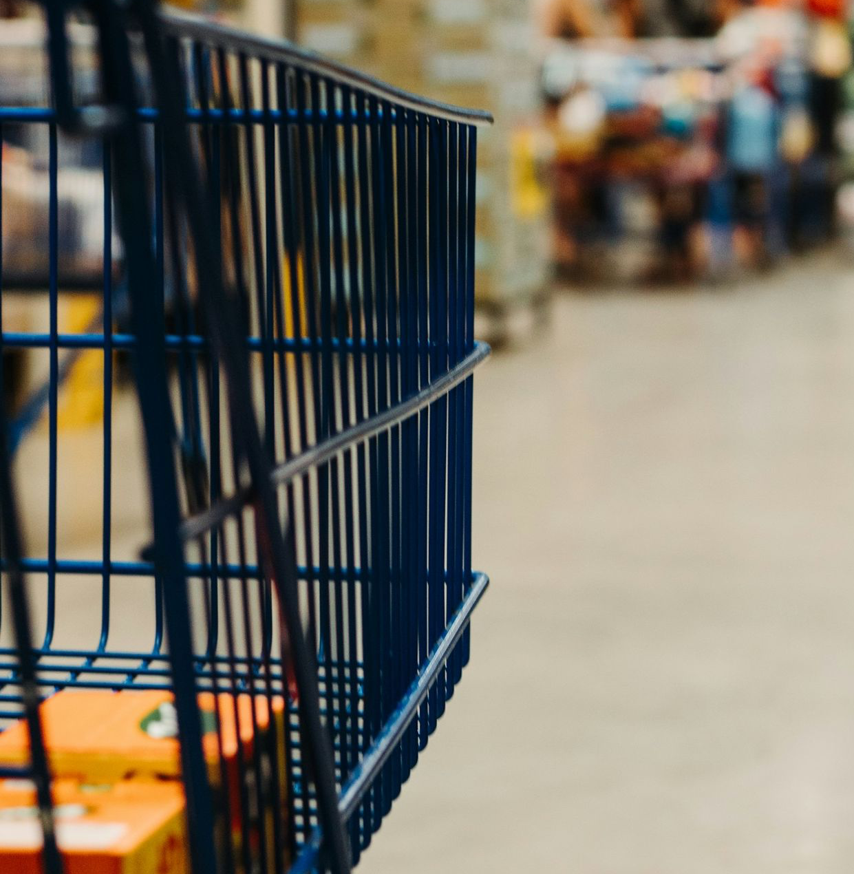 blue shopping cart on street during daytime